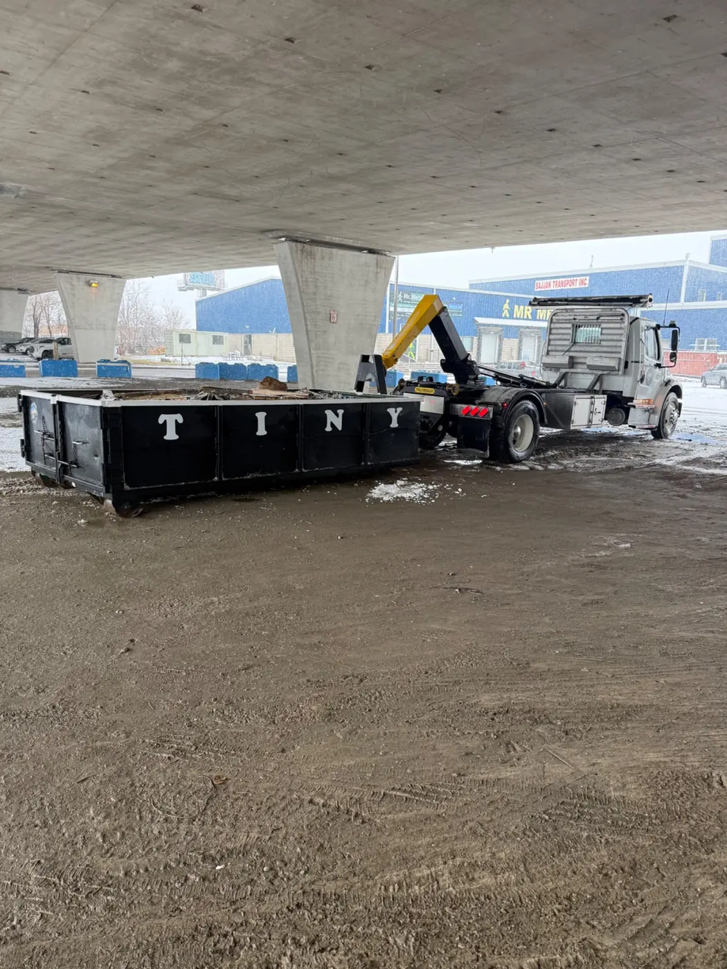 Tiny Bins truck under bridge